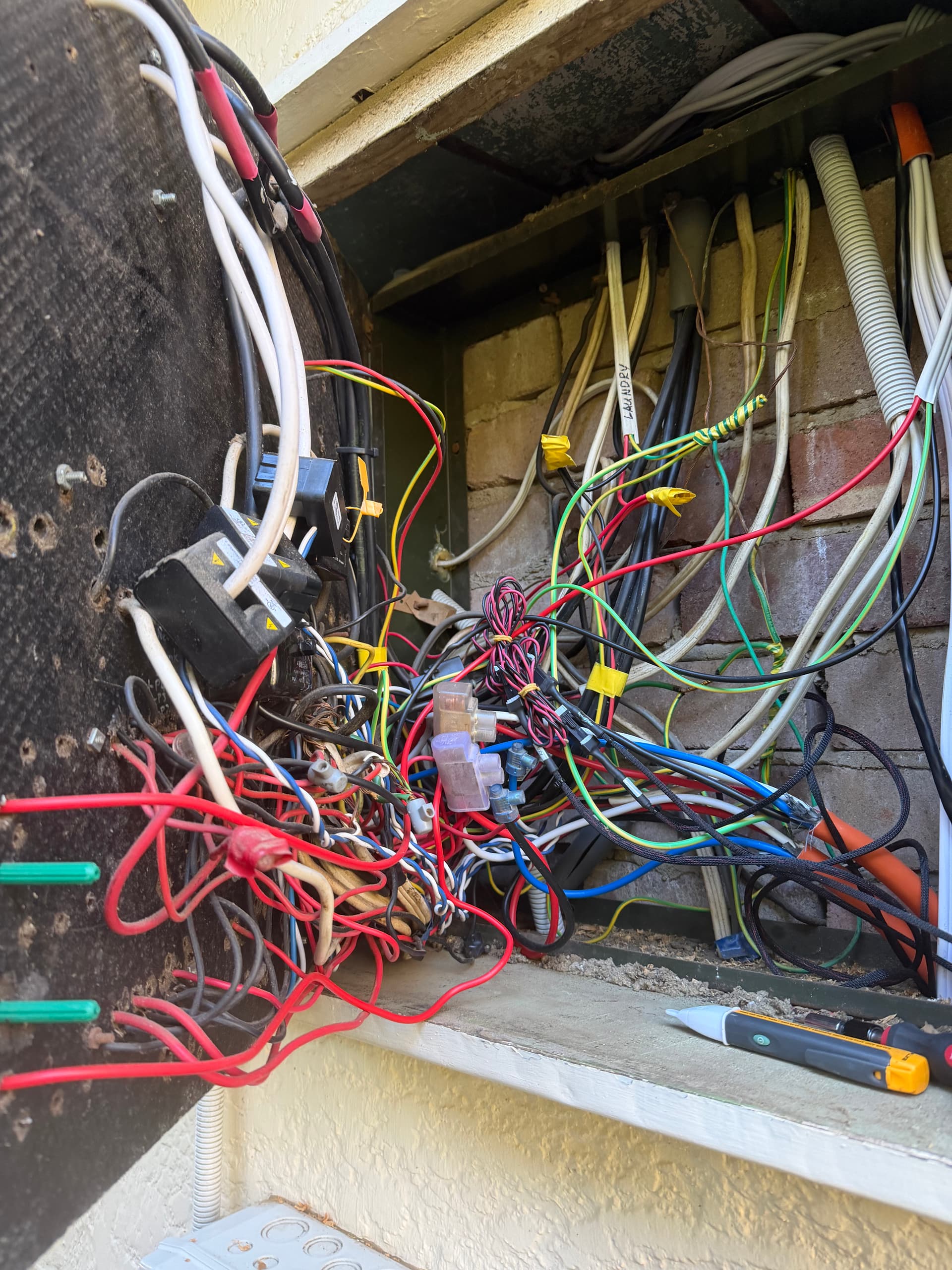 Messy residential switchboard before upgrade work in Sydney